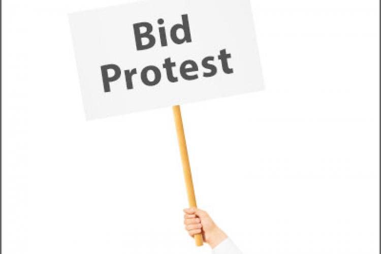 A hand holding a sign that says, "Bid Protest"